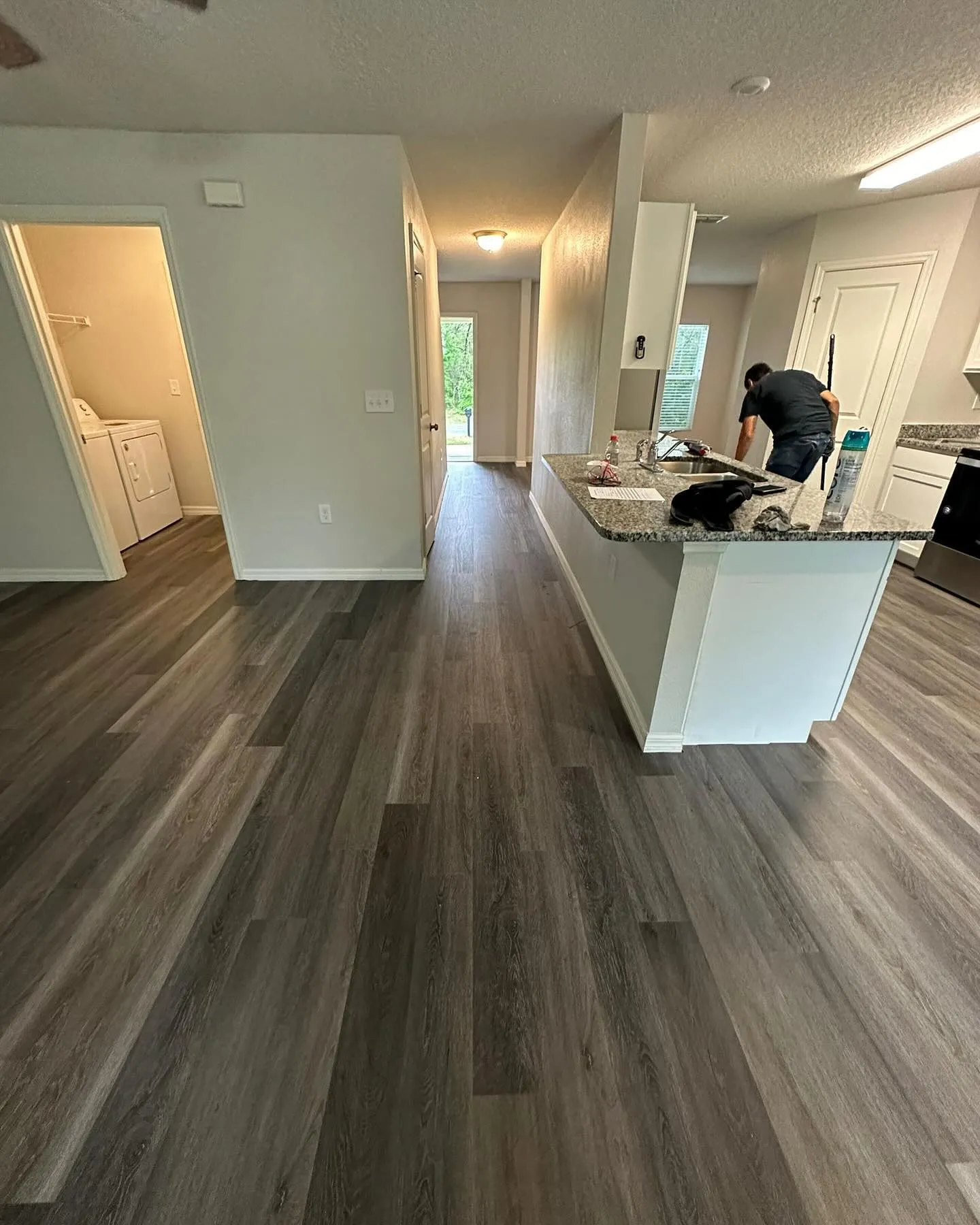 Vinyl plank installation in an open kitchen and hallway