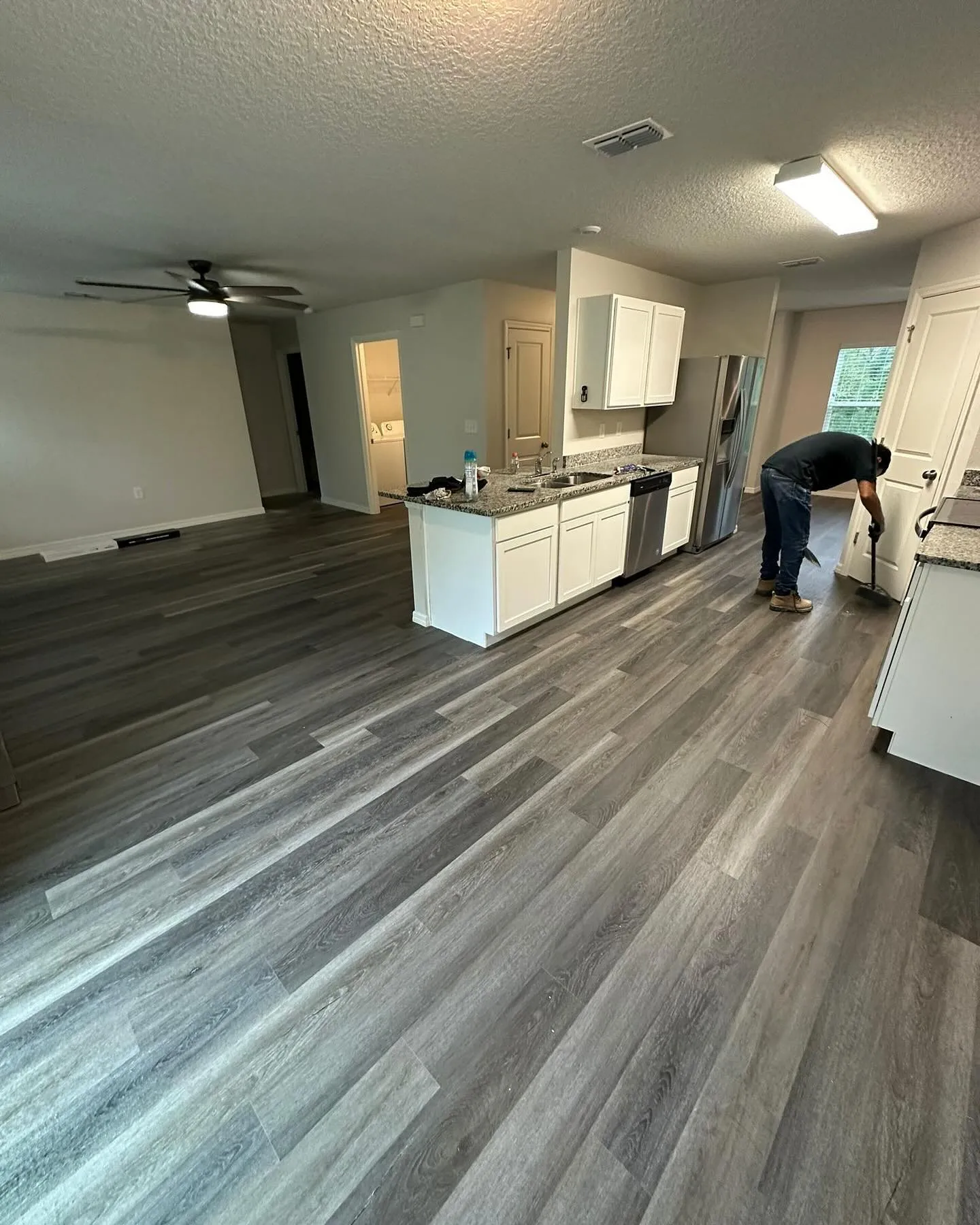 Gray vinyl plank in a modern kitchen with island